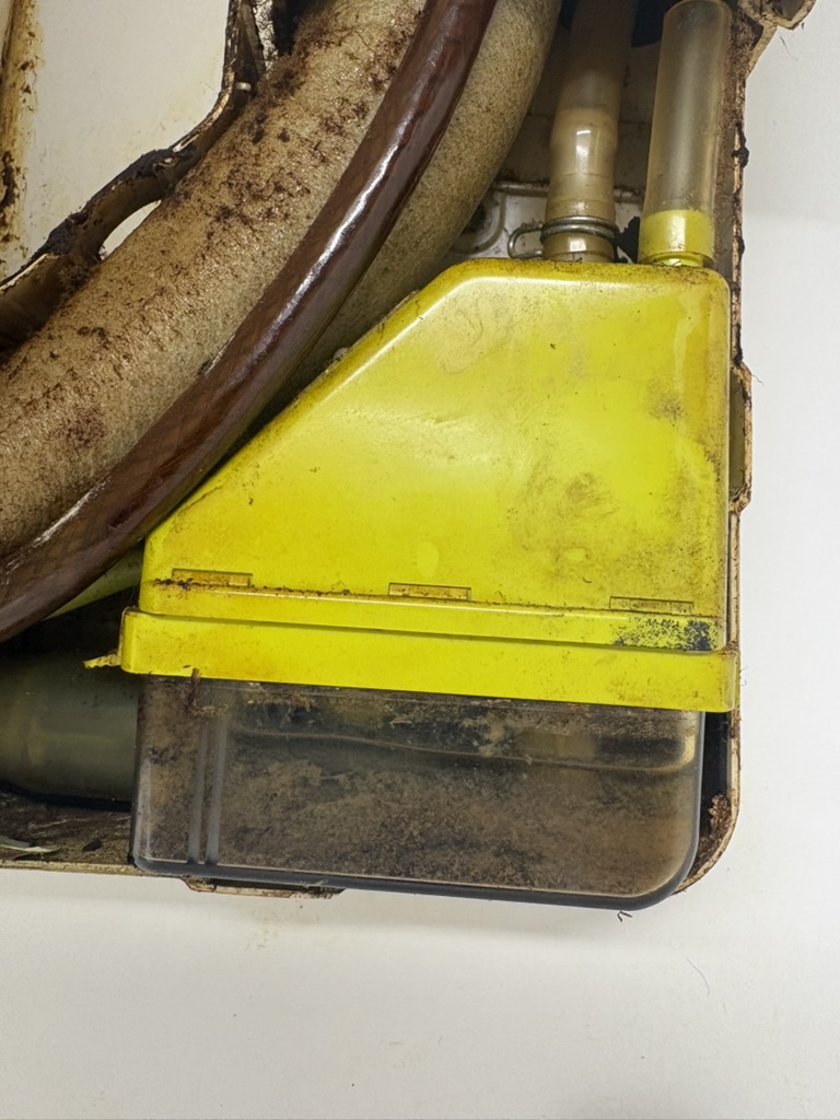 Air conditioning condensate pump installed with dirt and sludge in its reservoir