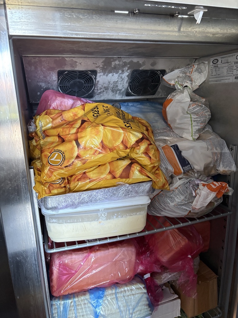 Commercial freezer cabinet overstocked in front of its internal air outlets