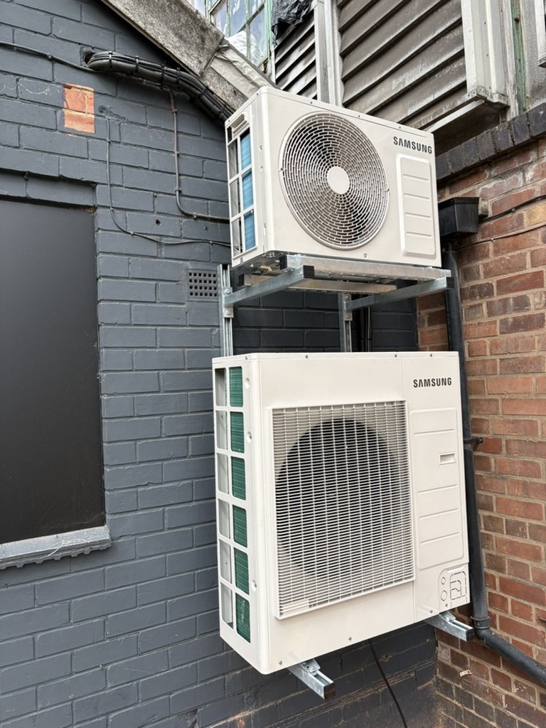 Two Samsung outdoor air conditioning units mounted outside Shredfast fitness studio