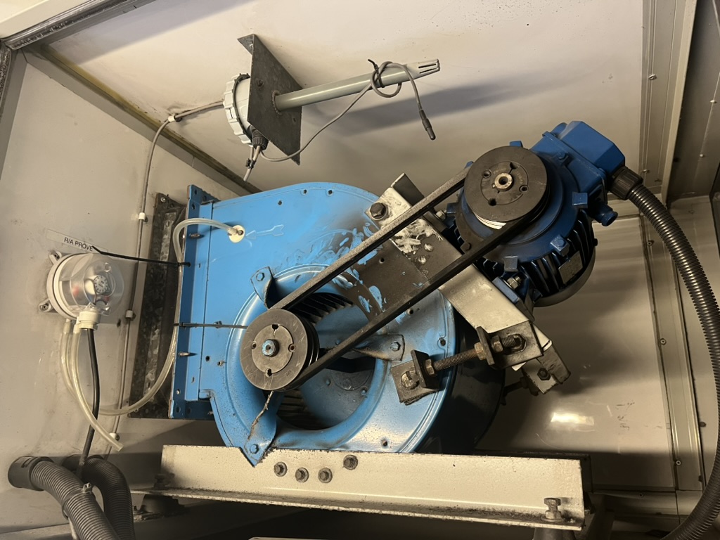Belt-driven centrifugal ventilation fan opened for inspection