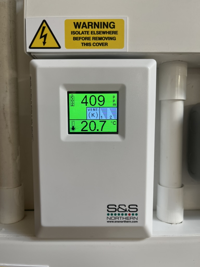 Ventilation controller displaying indoor carbon dioxide and temperature readings